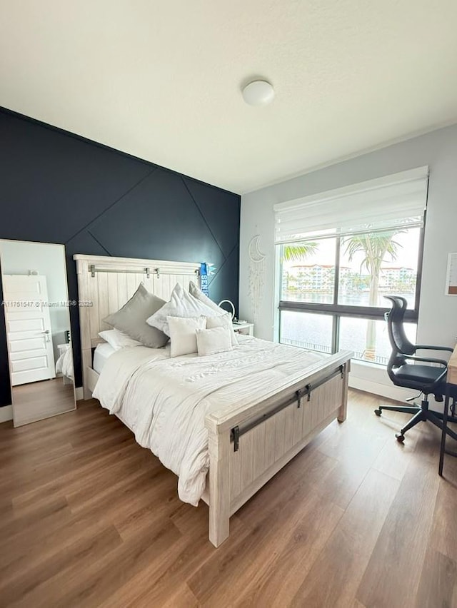 4640 NW 84th Ave Unit 13, Doral, FL 33166 - bedroom featuring wood finished floors and a desk
