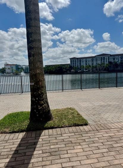 4640 NW 84th Ave Unit 13, Doral, FL 33166 - view of patio / terrace featuring a water view