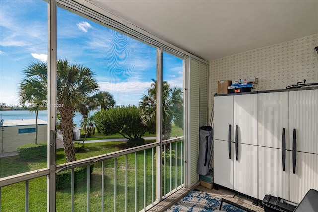 sunroom with a water view and a wealth of natural light