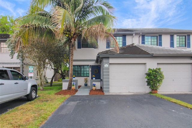 view of property featuring driveway and stucco siding