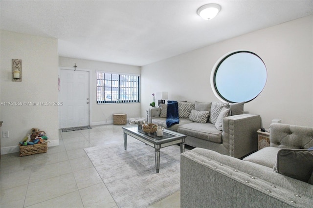 living room with light tile patterned floors and baseboards