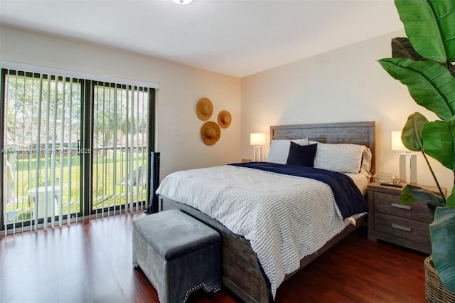 bedroom with access to exterior and wood finished floors