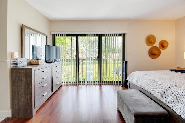 bedroom featuring access to outside and dark wood-style flooring