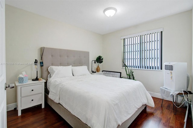 bedroom featuring baseboards and wood finished floors