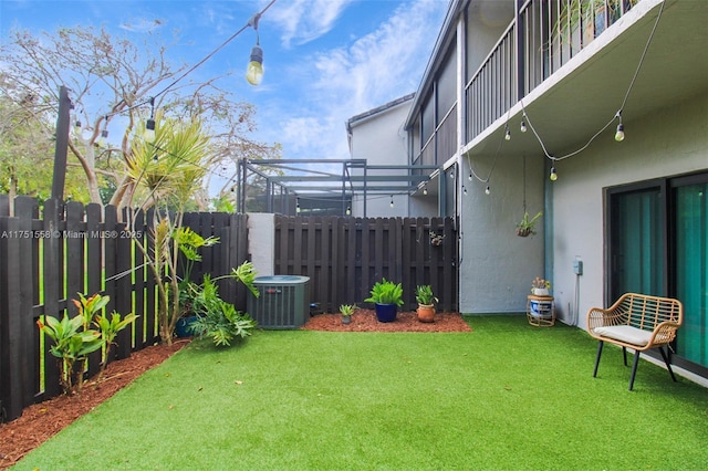 view of yard featuring central AC, fence, and a pergola