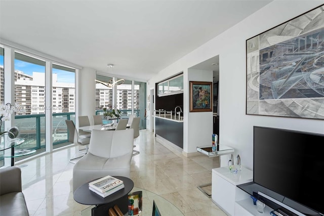 living room with expansive windows, marble finish floor, and a city view