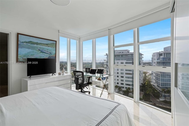 bedroom with expansive windows, a view of city, and multiple windows