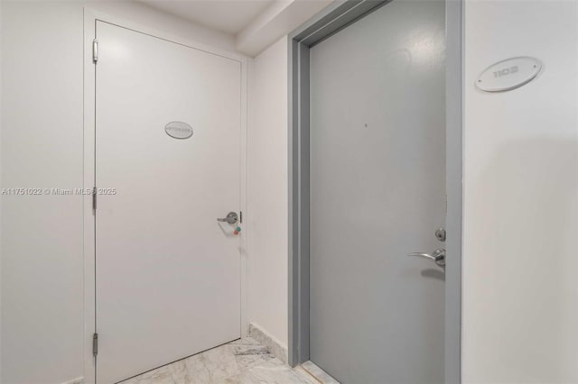 bathroom with marble finish floor