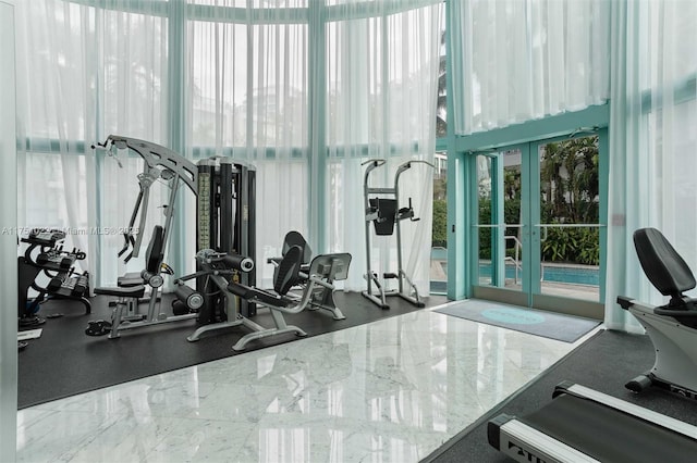 workout area with floor to ceiling windows and french doors