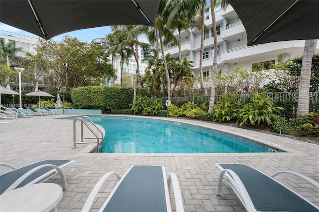 pool featuring a patio area and fence