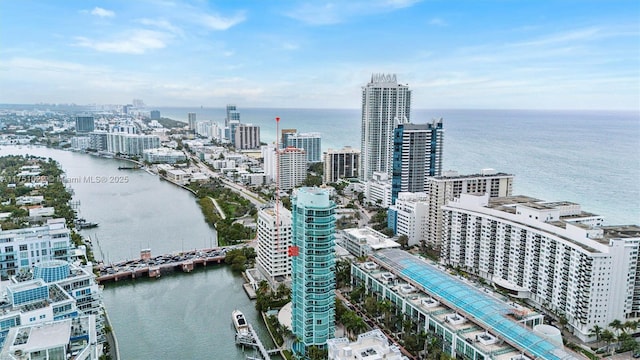 birds eye view of property featuring a view of city and a water view