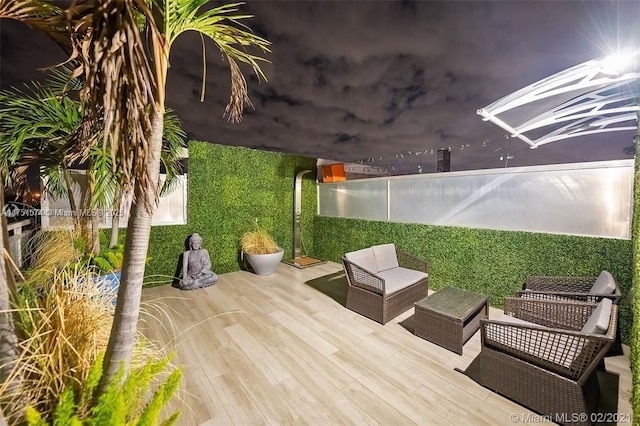 view of patio / terrace featuring fence, outdoor lounge area, and a wooden deck