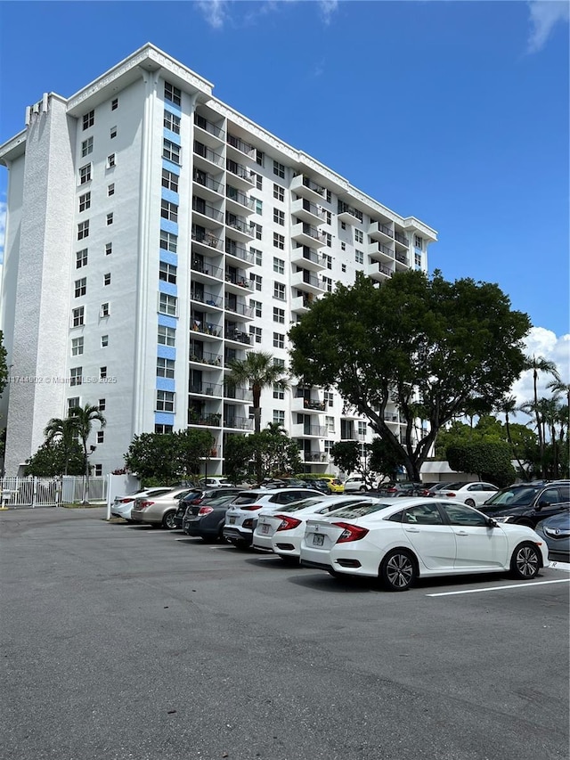 view of building exterior with uncovered parking