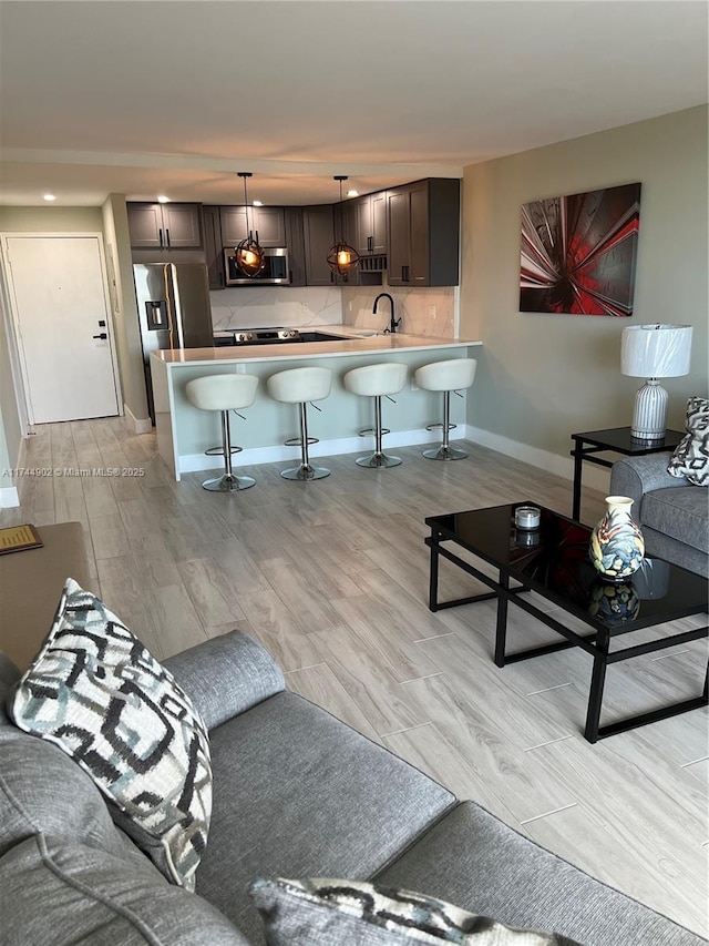 living area with light wood finished floors and baseboards