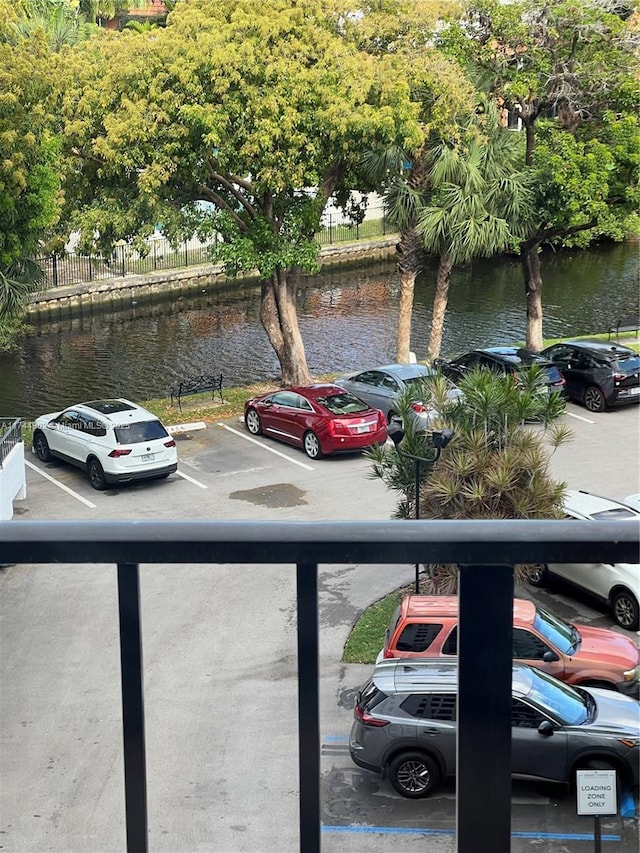 uncovered parking lot featuring a water view