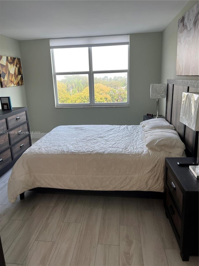 bedroom featuring light wood-type flooring and multiple windows