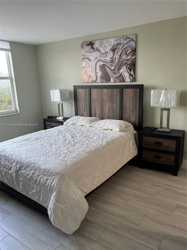 bedroom featuring light wood-style flooring