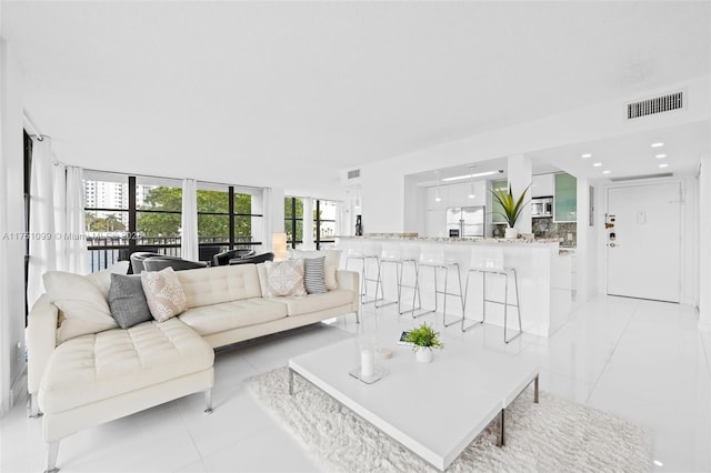 living room with visible vents and light tile patterned flooring