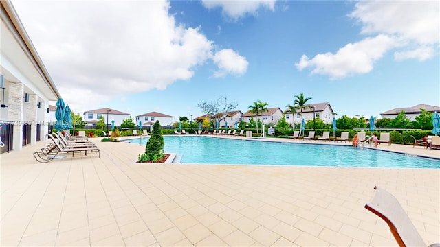 community pool featuring a patio area and fence