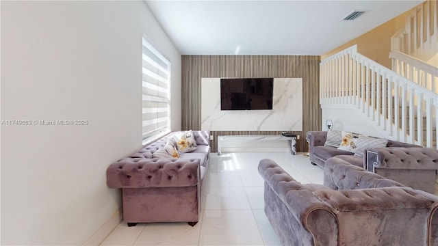 living room with stairway and visible vents