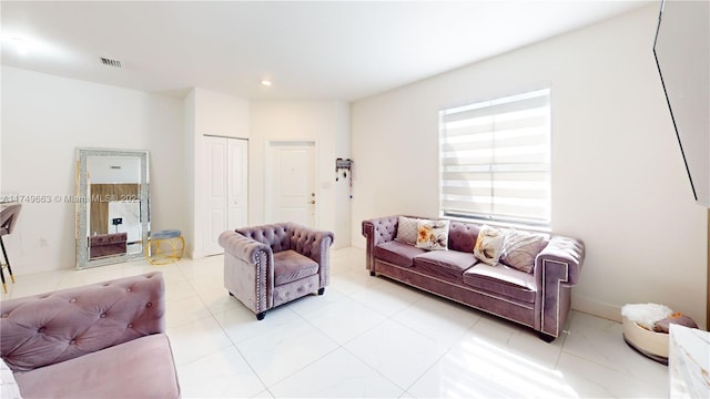 living area featuring visible vents and recessed lighting