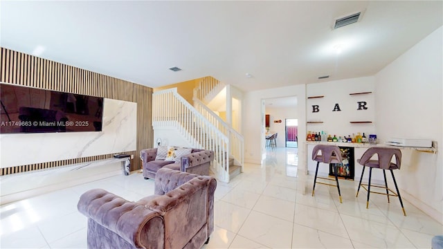 living room featuring stairs, marble finish floor, and visible vents