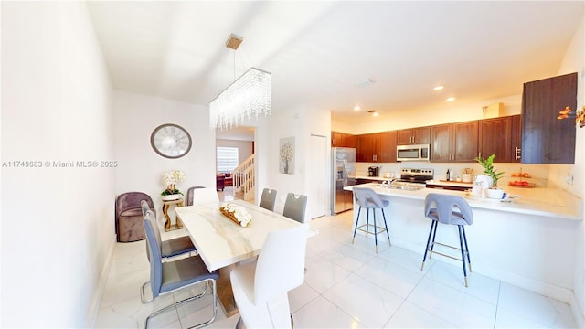 dining space with recessed lighting, baseboards, and stairs