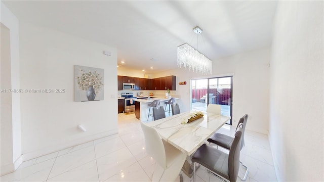 dining space with recessed lighting, marble finish floor, and baseboards