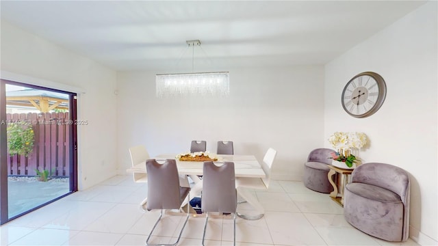 dining room with light tile patterned floors and an inviting chandelier