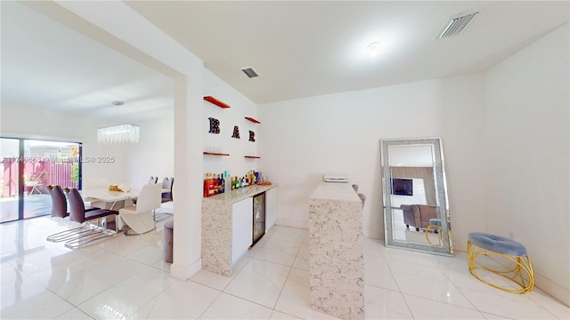 kitchen featuring marble finish floor, visible vents, and pendant lighting