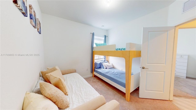 bedroom with carpet, visible vents, and baseboards