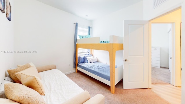 bedroom featuring carpet flooring and baseboards