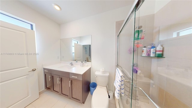 full bathroom with toilet, a shower stall, vanity, and tile patterned floors