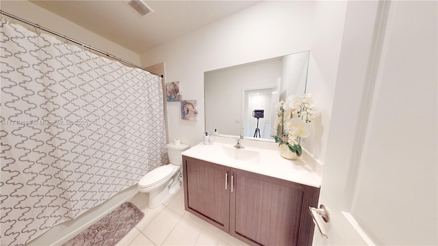 bathroom with visible vents, toilet, vanity, and tile patterned floors