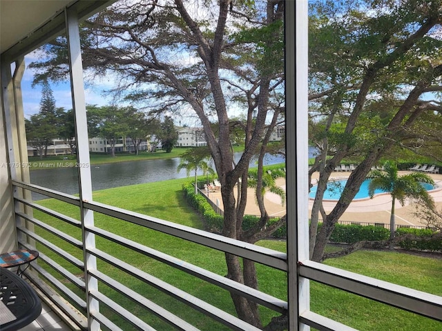 unfurnished sunroom with a water view