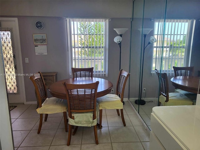 dining area with plenty of natural light, baseboards, and light tile patterned floors