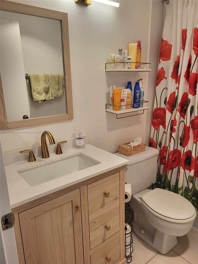 bathroom with toilet, tile patterned floors, and vanity