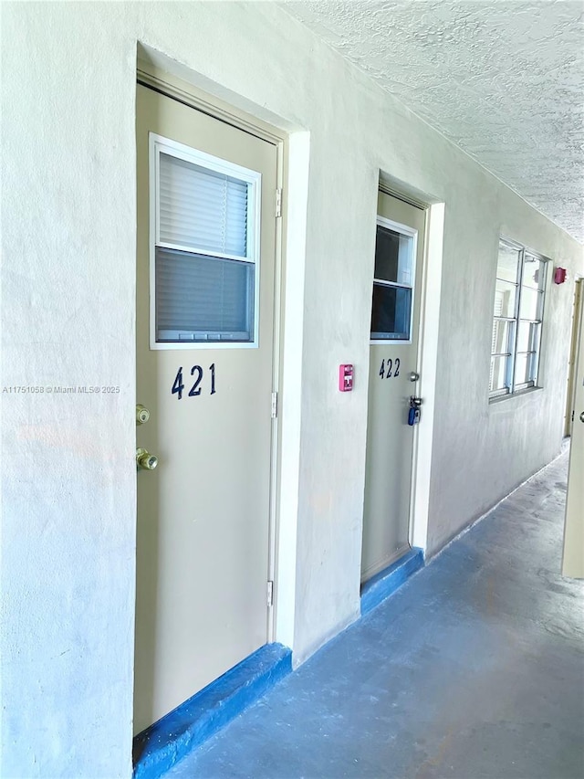 entrance to property with stucco siding