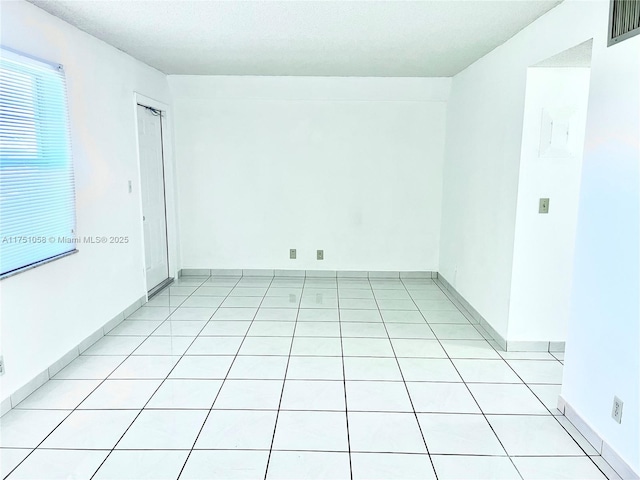 unfurnished room featuring light tile patterned floors and visible vents