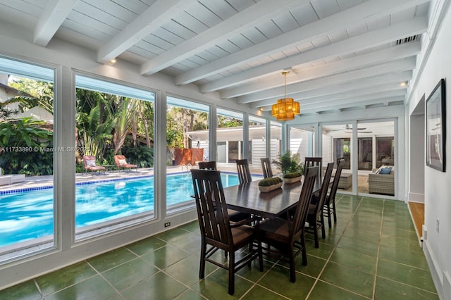 sunroom / solarium featuring beam ceiling