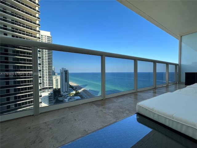 balcony with a water view and a city view