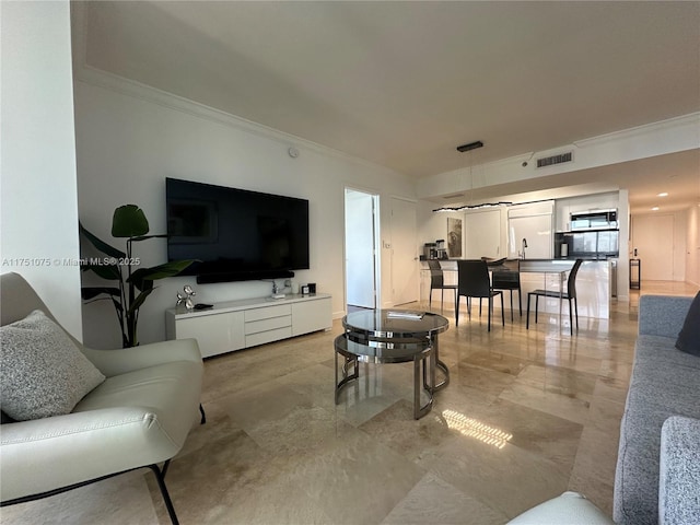 living room with visible vents and crown molding