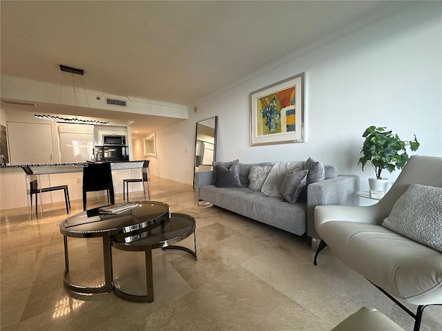 living area with visible vents, crown molding, and baseboards