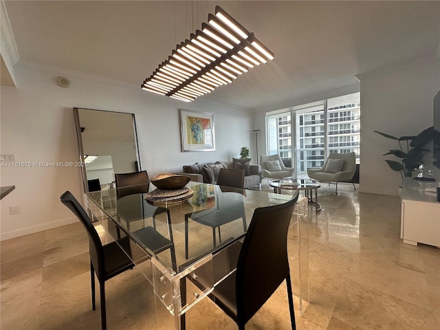 dining area featuring crown molding and baseboards