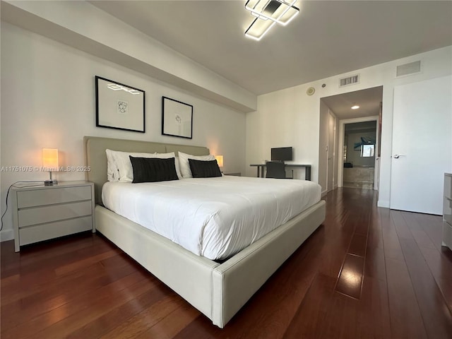 bedroom featuring dark wood-style floors and visible vents