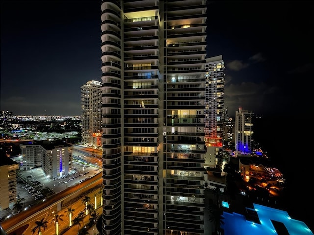 property at twilight with a view of city lights