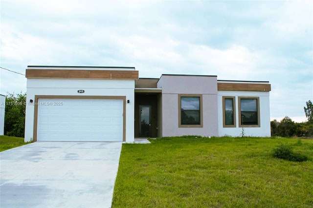 view of front of property with a garage, a front yard, concrete driveway, and stucco siding