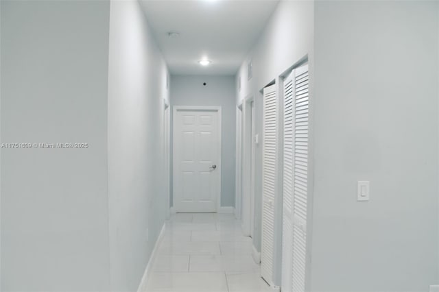 corridor featuring baseboards