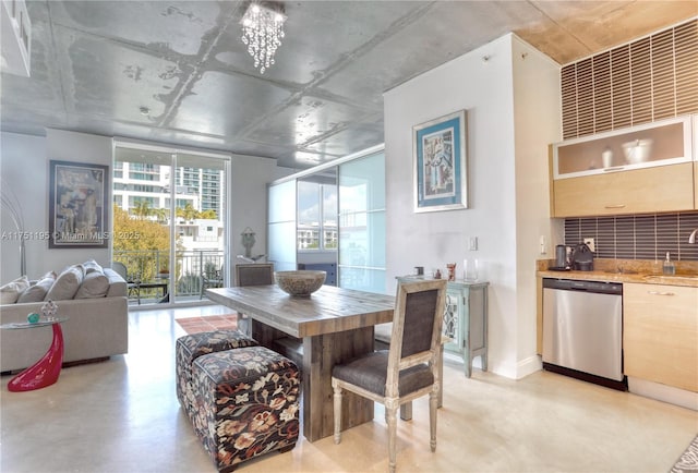 dining room with a notable chandelier and finished concrete flooring