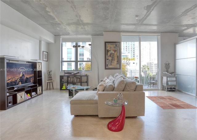 living area featuring expansive windows and concrete floors